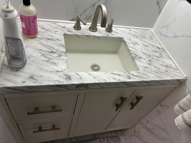 Bathroom featuring marble look tiles and vanity | Image 28
