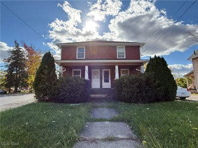 View of front of property featuring a porch and a front lawn | Image 1