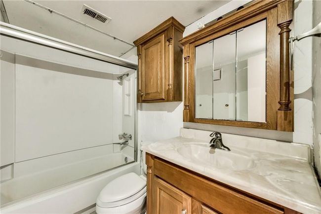 Bathroom featuring vanity and shower / tub combination | Image 13