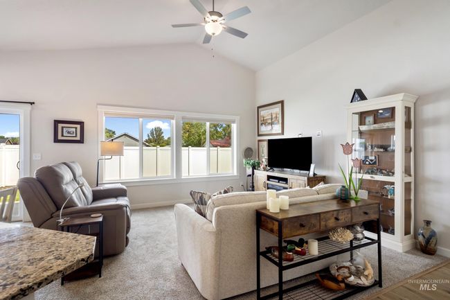 Living area featuring ceiling fan, high vaulted ceiling, and wood finished floors | Image 11
