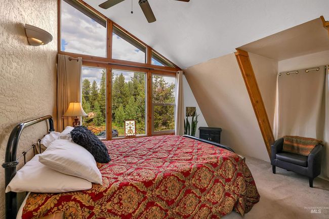 Bedroom with lofted ceiling, carpet floors, and a ceiling fan | Image 31