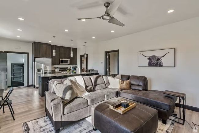 Living area featuring light wood-style floors, recessed lighting, ceiling fan, and baseboards | Image 25