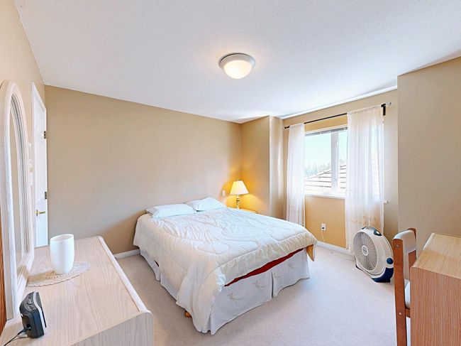 Bedroom featuring light colored carpet and baseboards | Image 26