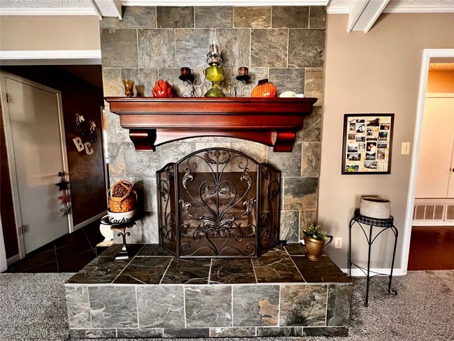 Room details featuring crown molding and a fireplace | Image 4
