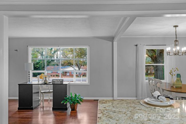 Formal living room is being utilized as a home office | Image 17