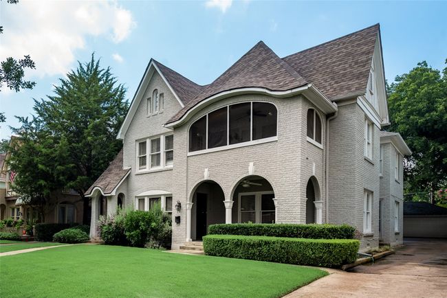 View of front of home with brick siding, a front yard, and roof with shingles | Image 5