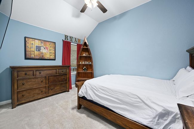 Bedroom featuring vaulted ceiling, light colored carpet, and ceiling fan | Image 21