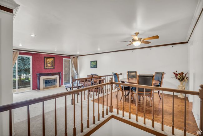 Interior space featuring ornamental molding, ceiling fan, recessed lighting, and a premium fireplace | Image 5