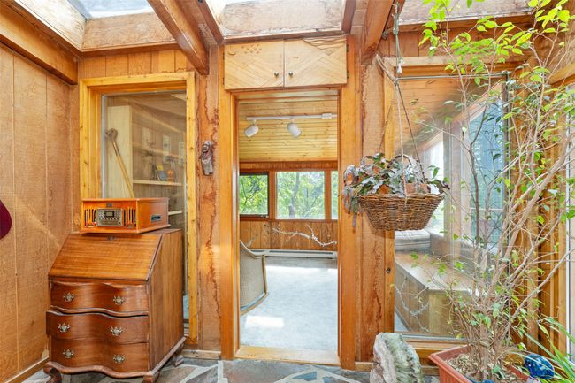 Bathroom with wood walls and a baseboard heating unit | Image 15