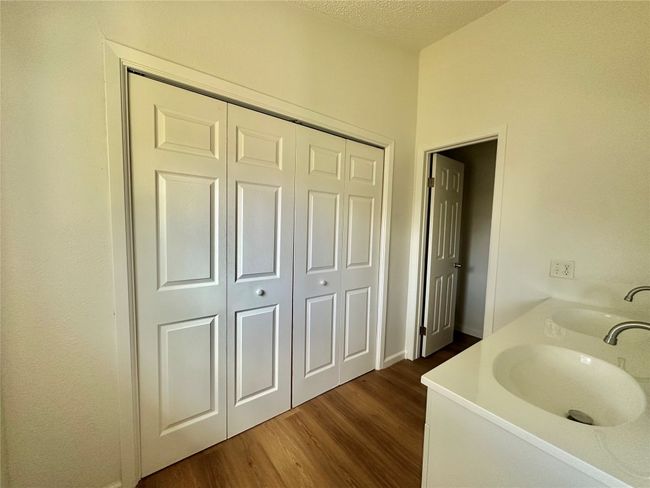 Bathroom with wood finished floors, a textured ceiling, and vanity | Image 15
