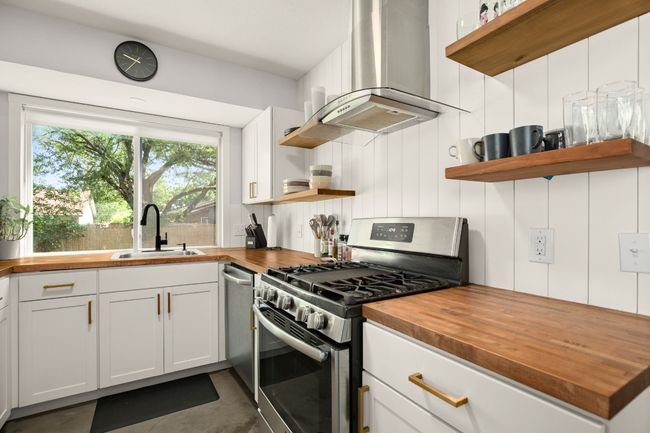 Kitchen with butcher block counters and open shelves | Image 10