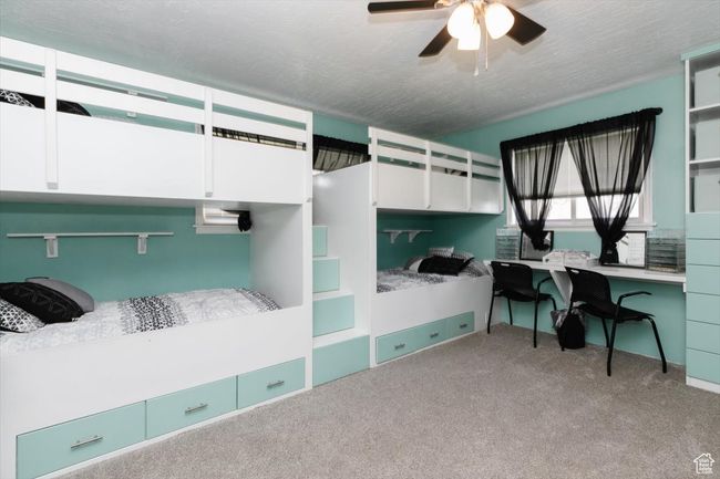 Bedroom featuring carpet floors, ceiling fan, and a textured ceiling | Image 20