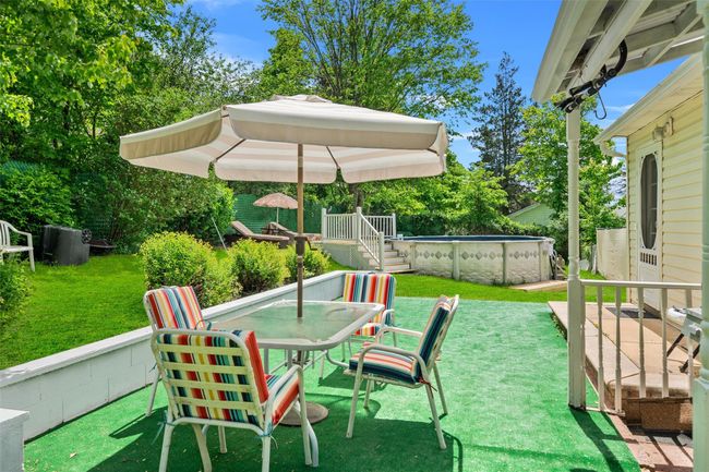 View of patio featuring an outdoor pool, outdoor dining area, and a wooden deck | Image 25