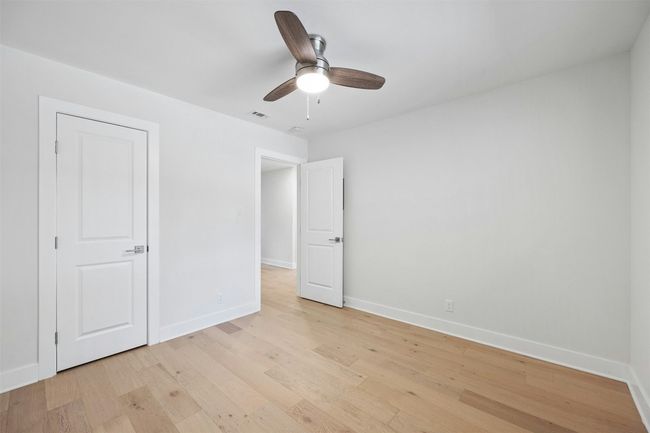 Unfurnished bedroom featuring light wood-style floors and ceiling fan | Image 25