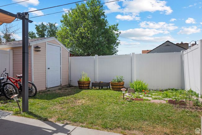 Fenced backyard featuring a storage shed | Image 22
