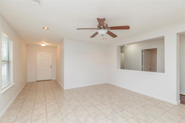 Bright Living Room. Spacious living area featuring large windows that fill the space with natural light. | Image 6