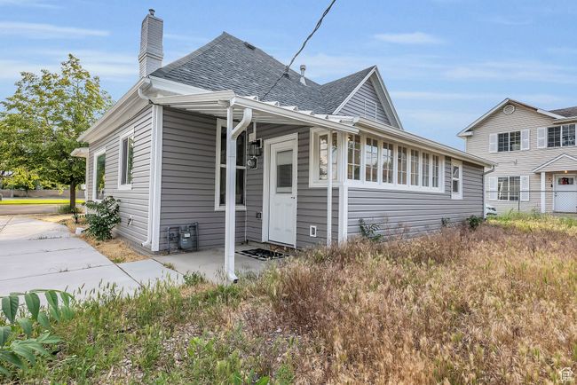 View of front of house featuring roof with shingles and a chimney | Image 18