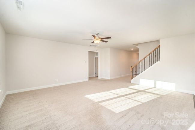 Open Family Room showing entrance from Foyer, entrance to Primary (on the left), Laundry/Mud Rm (on the right)and on the other side of the home, to the immediate left as you enter the home is a hallway where 2 other spacious bedrooms, roomy (even 1 is a walk-in) closets in each, and full bath are located. | Image 20