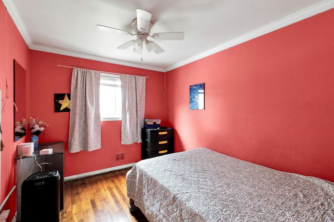 Bedroom featuring wood-type flooring, baseboards, ornamental molding, and a ceiling fan | Image 6