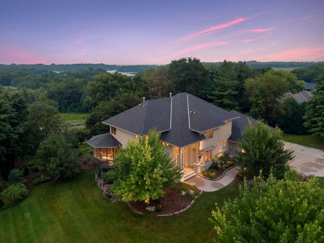 Absolutely gorgeous curb appeal nestled on a fabulous, .87 acre lot! Custom built, stylish, modern window and stone accents, beautiful mature trees along the serene lakeshore on a fabulous south metro recreational/fishing lake. | Image 54