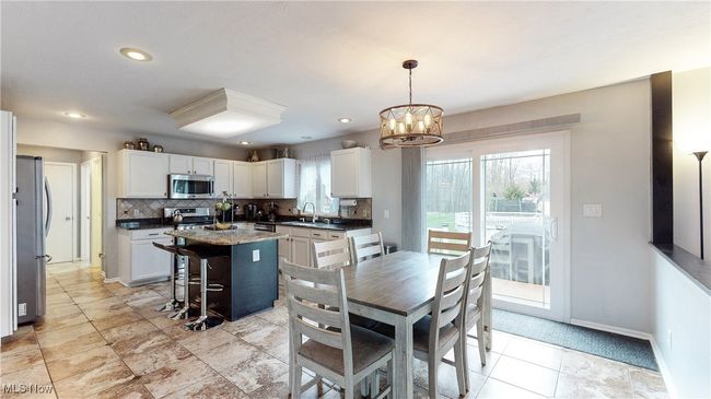 EAT IN KITCHEN WITH CERAMIC TILE FLOORING, STONE COUNTERTOPS, UPDATED LIGHTING AND SS APPLIANCES. | Image 9