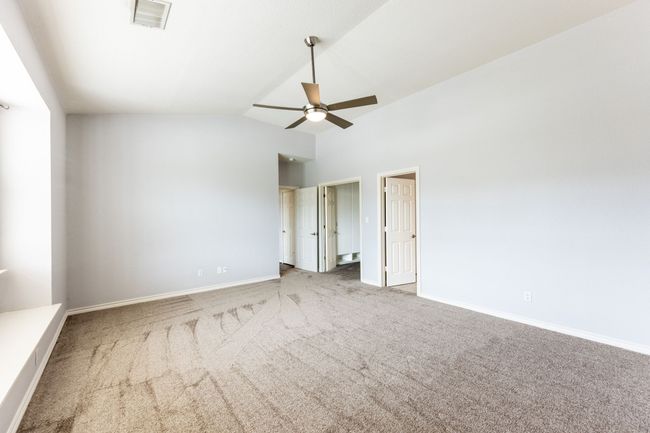 Spare room featuring carpet, a ceiling fan, and lofted ceiling | Image 15