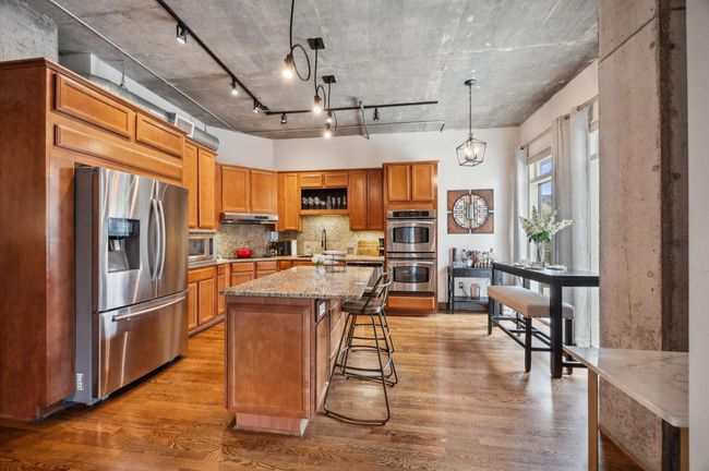 A modern kitchen equipped with a double oven, microwave, refrigerator and sleek stainless steel appliances—all included | Image 16