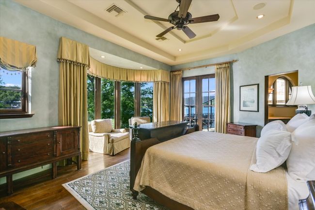 Bedroom with a raised ceiling, visible vents, recessed lighting, and wood finished floors | Image 29