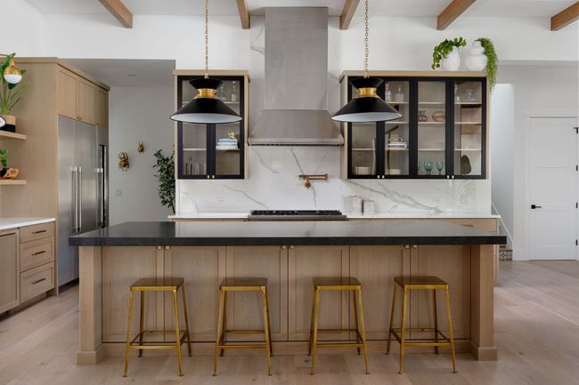 Kitchen with wall chimney exhaust hood, high end refrigerator, tasteful backsplash, and beamed ceiling | Image 9