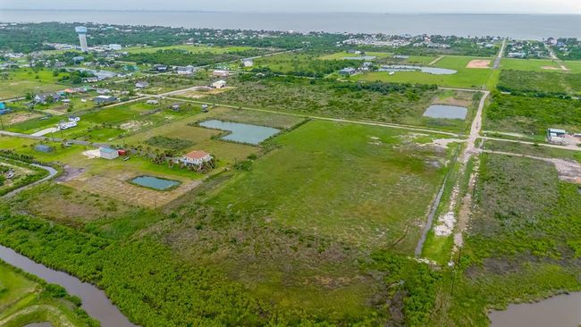 The area’s natural appeal shines through in this elevated view, with a patchwork of fields, ponds, and serene streams enhancing the coastal backdrop. | Image 46