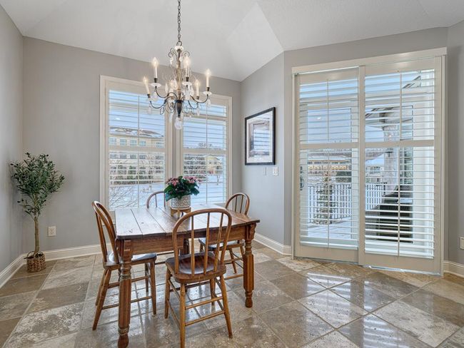 Informal dining area surrounded by windows and flows out to the maintenance free deck. | Image 11
