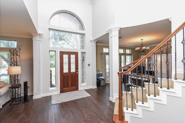 As you enter your front door you are greeted with sky high ceilings and a bright, airy atmosphere. Note the gorgeous wood-look tile throughout your home! Immediately to your left is your formal dining room/study. | Image 4