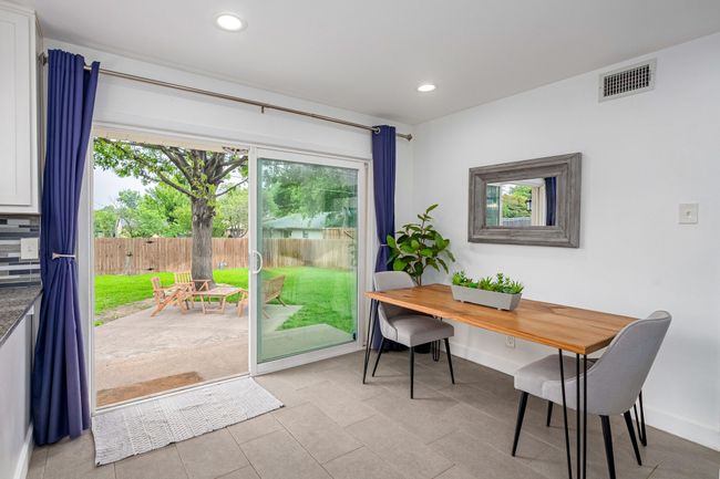 The dining area has lots of natural lighting. | Image 11