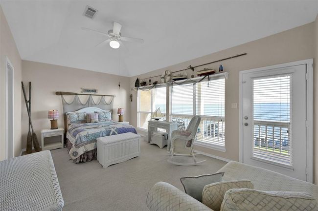 Wake up to beautiful lake views in this charming and spacious primary suite. | Image 14