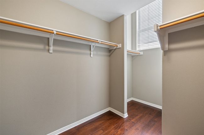 Spacious closet with wood finished floors | Image 22