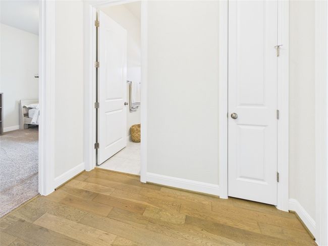 Corridor with baseboards and light wood-type flooring | Image 16
