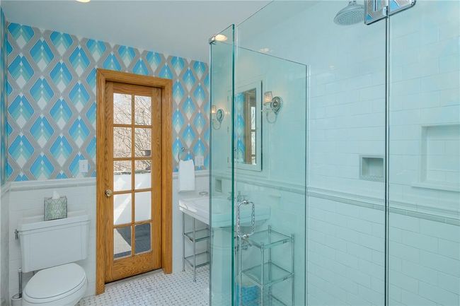 2nd Hall Full Bath, marble basket weave floor, pedestal sink, frameless glass shower enclosure, door to balcony | Image 24