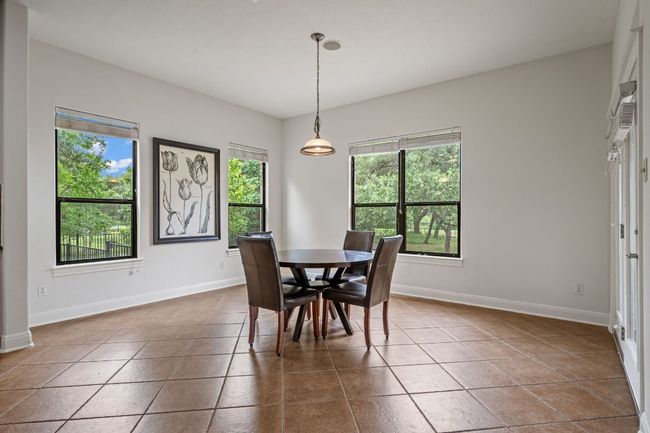 Dining space featuring dark tile patterned floors and baseboards | Image 14