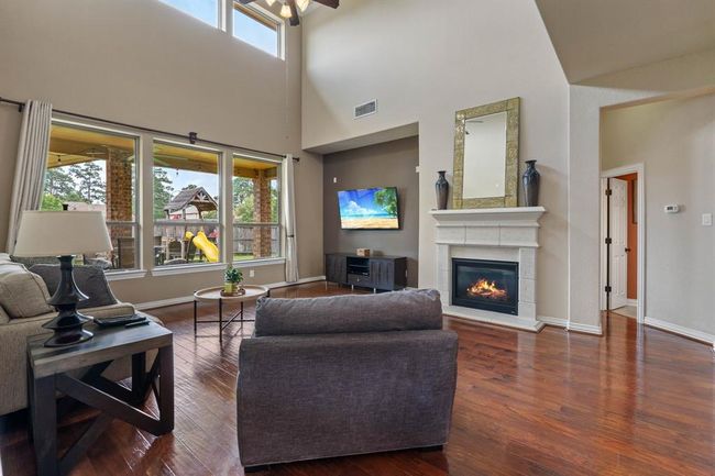Enjoy the vaulted ceilings and cozy fireplace. | Image 9