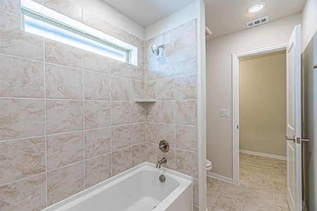 Bathroom featuring shower combination and toilet | Image 40