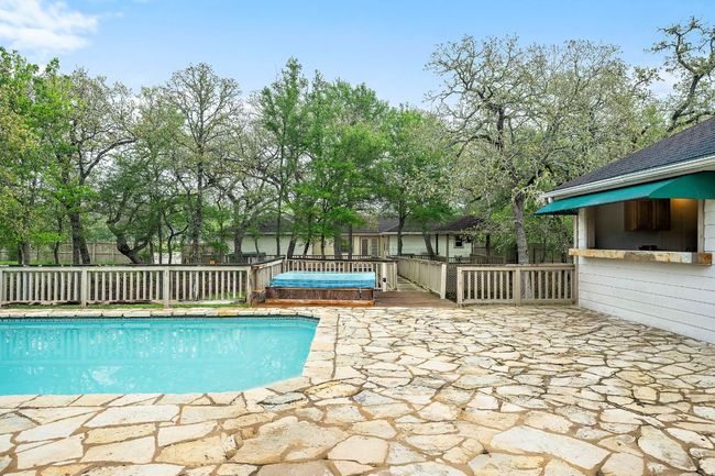 View of the pool looking back towards the house and kitchen opening up to the pool. | Image 27