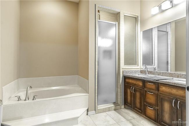 Bathroom with vanity, tile patterned floors, and separate shower and tub | Image 14