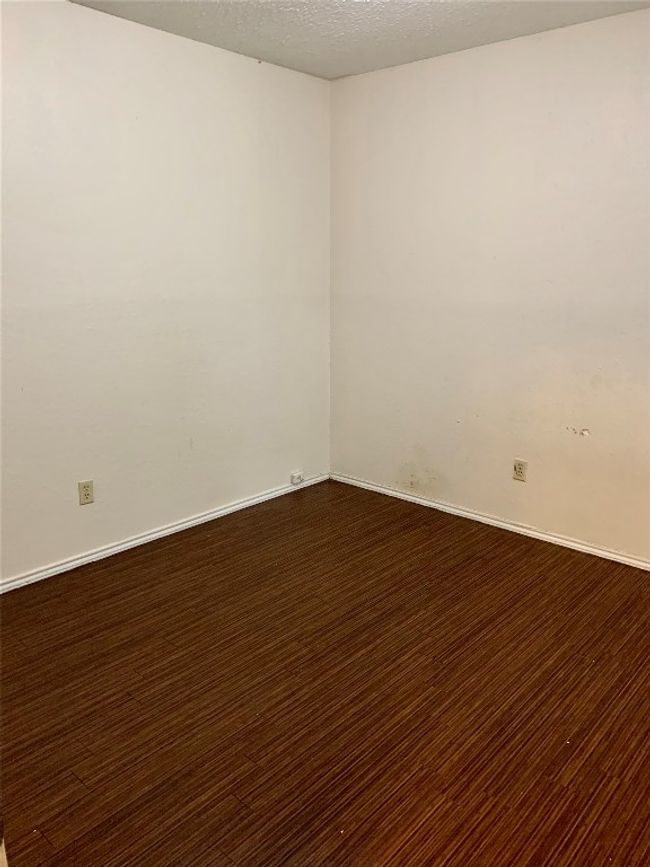 Unfurnished room featuring baseboards and a textured ceiling | Image 8