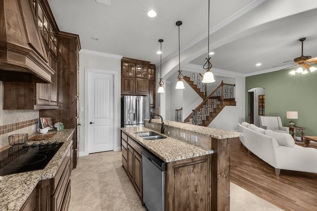 Kitchen with a sink, appliances with stainless steel finishes, arched walkways, recessed lighting, and backsplash | Image 20