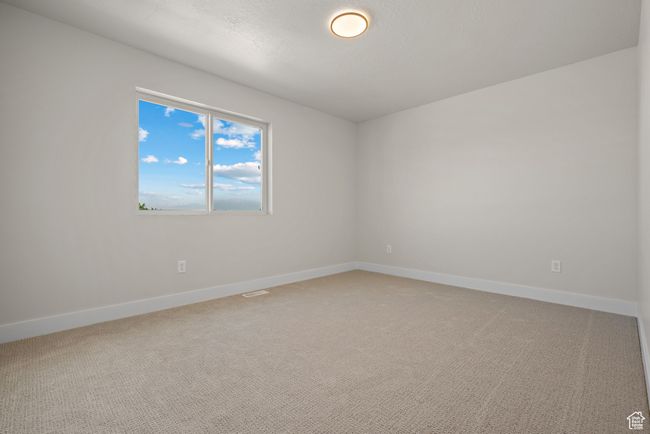 Empty room featuring baseboards and light colored carpet | Image 24