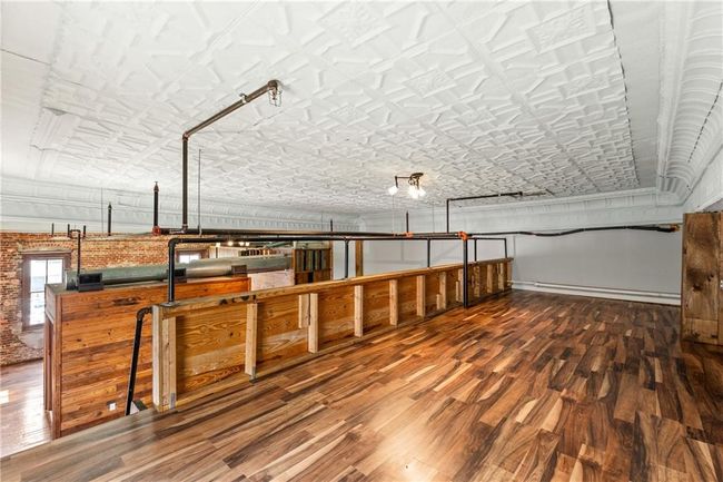 Miscellaneous room with an ornate ceiling and wood finished floors | Image 6