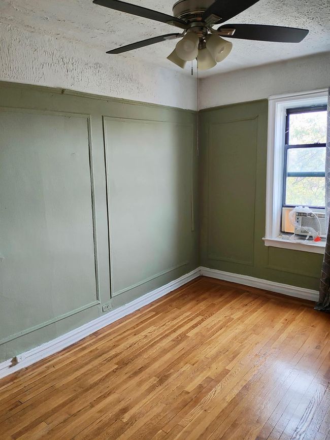 Unfurnished room with baseboards, cooling unit, light wood-style flooring, and a ceiling fan | Image 17
