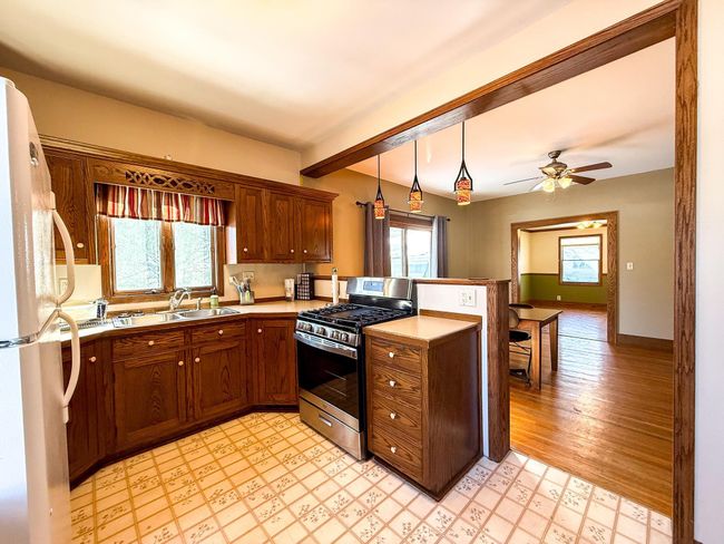 Kitchen, dining, and entryway flow easily providing a unique functional space | Image 5