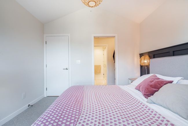 Bedroom with lofted ceiling, carpet, baseboards, and ensuite bathroom | Image 19