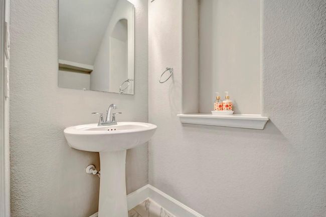 Half bath for guests is discreetly located just off the mudroom. | Image 23
